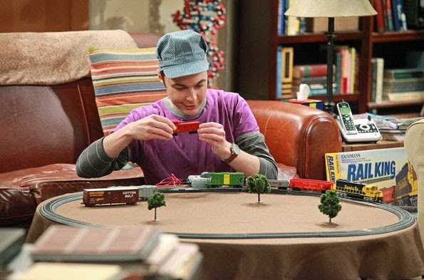 sheldon from the big bang theory with a model train